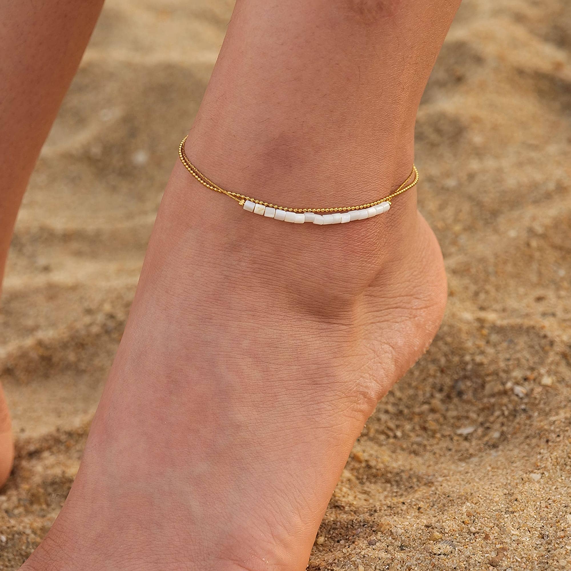 Delicate gold anklet with white bead accents, perfect for beach or casual wear. High-quality jewelry from Monalisa Store to elevate your summer style.