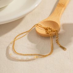 Luxurious gold jewelry featuring delicate chains and white beaded accents, ideal for jewelry shopping, gift-giving, and enhancing your fashion style.