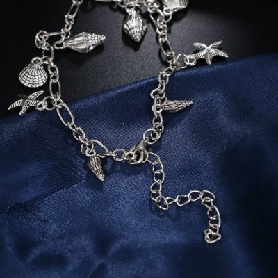 Elegant silver beach-themed jewelry for women and men, featuring seashells, starfish, and ocean-inspired charms, perfect for summer accessories and coastal fashion.