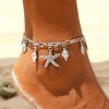 Delicate silver beach-themed anklet with starfish, shell, and ocean charm, perfect for summer or beachwear. Made of high-quality sterling silver, lightweight, and comfortable for everyday or vacation accessories.