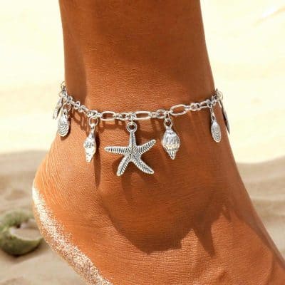 Delicate silver beach-themed anklet with starfish, shell, and ocean charm, perfect for summer or beachwear. Made of high-quality sterling silver, lightweight, and comfortable for everyday or vacation accessories.