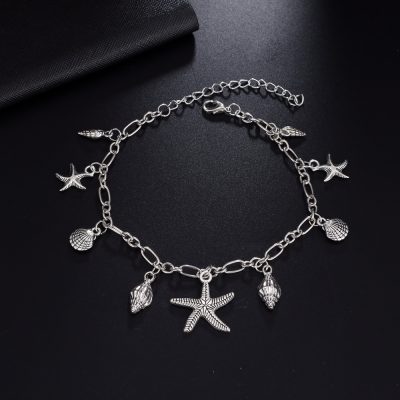 Silver beach-themed charm necklace with starfish, shells, and seashell pendants, perfect for summer jewelry lovers and seaside fashion. Elegant and stylish accessory for beach days.