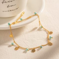 Delicate gold chain necklace featuring small turquoise beads and round gold charms, perfect for stylish women who love jewelry.