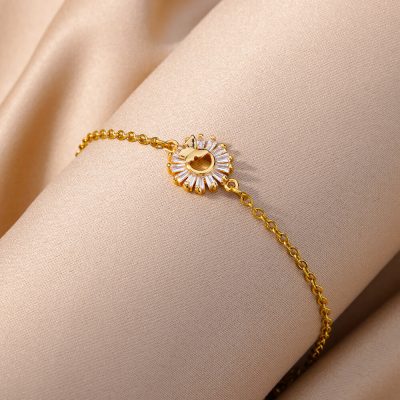 Sterling gold bracelet with a sparkling sun-shaped crystal centerpiece, perfect for stylish jewelry lovers.