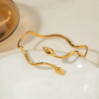 Gold snake bracelet jewelry featuring a sleek, modern design perfect for stylish accessories and gift ideas. Made from high-quality gold, ideal for sophisticated fashion statements.