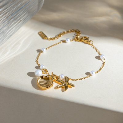 Gold chain necklace with white pearls and beach-themed charms, perfect for summer or casual wear. High-quality jewelry ideal for gifts or personal collection.