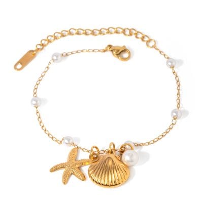 Delightful gold chain bracelet with white pearls and ocean-themed charms, perfect for adding a touch of seaside elegance to your look.