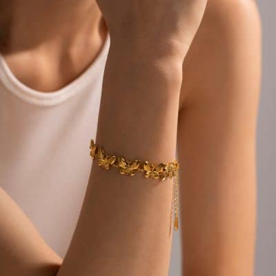 Delicate gold butterfly bracelet on woman's wrist, perfect for fashion and luxury jewelry collections, available at Monalisa Store.