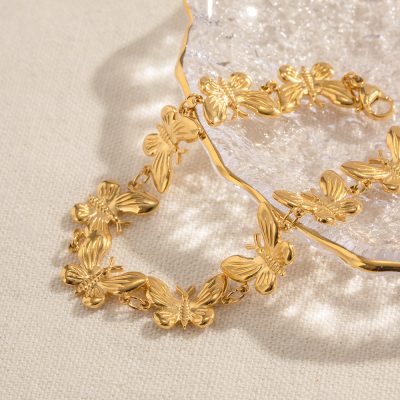 Elegant gold butterfly necklace and earrings jewelry set, perfect for women and special occasions, made of high-quality gold-plated material.