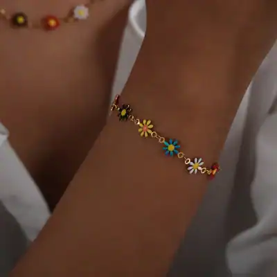 Vibrant flower charm bracelet with blue, white, yellow, red, and black flower designs, perfect for fashion and jewelry lovers.