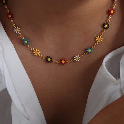Bright enamel flower necklace with multicolor daisies on gold chain, perfect for fashionable, casual, or playful jewelry looks.