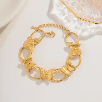 Delicate gold-toned butterfly necklace perfect for women, featuring intricate butterfly designs on linked circles, ideal for elegant accessories and daily wear.