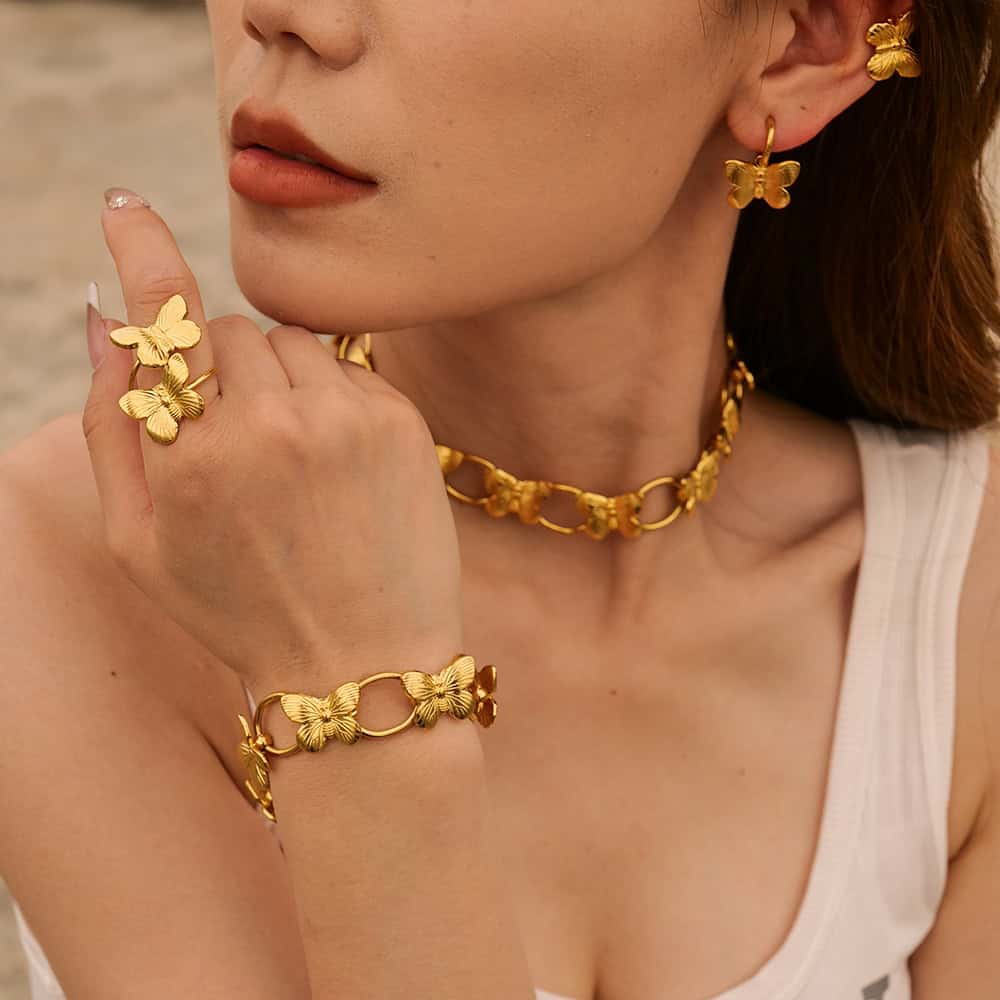 Gold butterfly earrings, bracelet, and necklace with intricate butterfly designs, perfect for stylish women. High-quality jewelry crafted for elegance and daily wear.