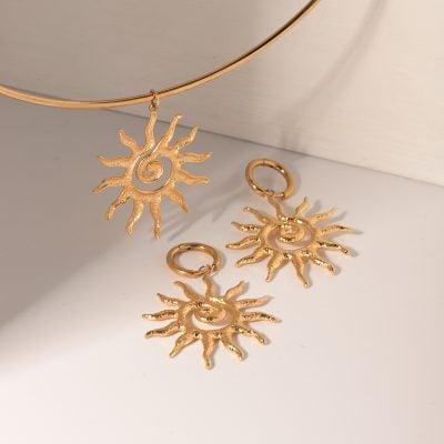 Elegant gold sun pendant and earrings set for stylish accessories. Crafted with shiny gold finish, perfect for enhancing your fashion with sun-inspired jewelry pieces.