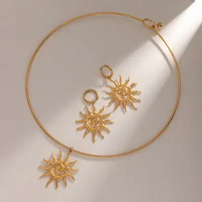 Dazzling gold sun-inspired necklace and earrings set, perfect for adding a radiant touch to any outfit. Crafted with high-quality materials, ideal for stylish occasions and gifting.