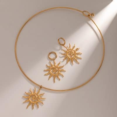 Elegant gold sun-themed jewelry including a necklace and matching earrings, perfect for stylish accessorizing and versatile fashion statements.