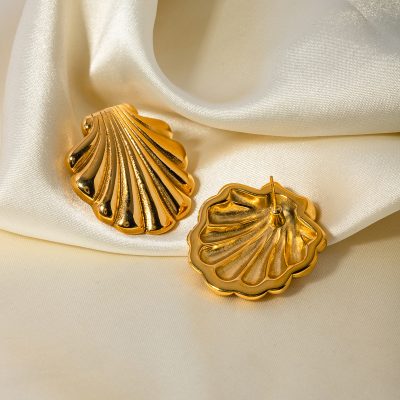 Gold shell-shaped earrings displayed on satin fabric, showcasing luxurious and fashionable jewelry for women. Perfect for special occasions, gift-giving, or everyday elegance.