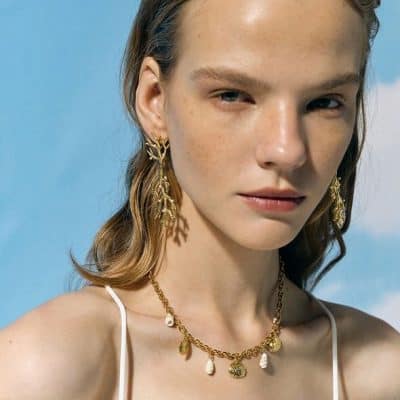 Stunning gold jewelry set featuring earrings and necklace with seashell and pearl accents, perfect for enhancing your style and elegance. Shop at Monalisa Store for unique accessories.