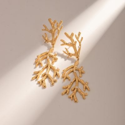 Elegant gold coral-shaped earrings decorated with small pearls, perfect for stylish jewelry collections and high-quality accessories.