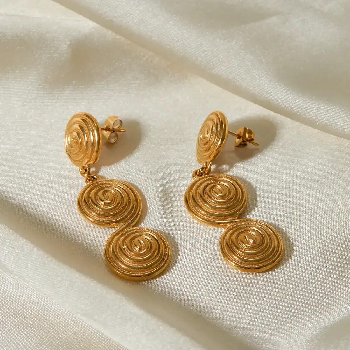 Gold spiral dangling earrings, stylish jewelry for women, perfect for parties and special occasions, made with high-quality gold-plated material, versatile accessory for fashion-forward looks.