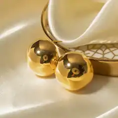 Luxury gold earrings with spherical design, ideal for elegant jewelry collections and stylish accessories. Perfect for enhancing sophisticated fashion looks.