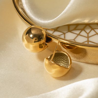 Shiny gold jewelry earrings with spherical accents, luxurious fashion accessories, ideal for special occasions or everyday elegance.