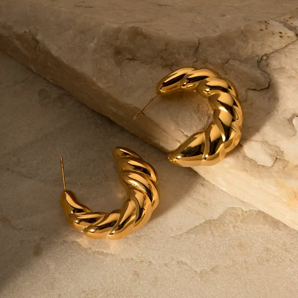 Stylish gold hoop earrings with a twisted, chunky design for women's fashion accessories. Perfect for everyday wear or special occasions, adding elegance to any outfit.