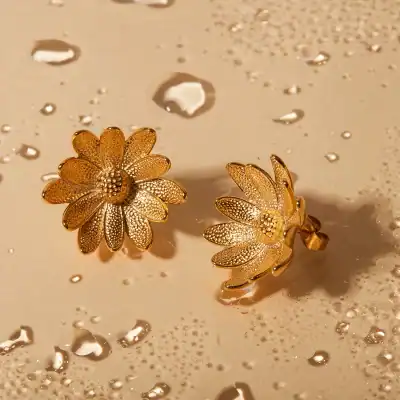 Beautiful gold flower-shaped earrings with detailed textures, perfect for elegant jewelry collection and gifting. Crafted with high-quality materials to add a touch of luxury.