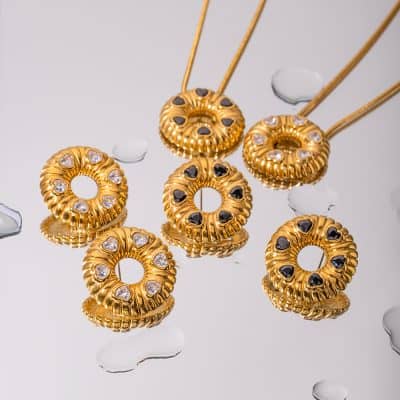 Beautiful gold ring holders with black and white gemstone accents, perfect for organizing and displaying rings. Elegant addition to any jewelry collection or store display.