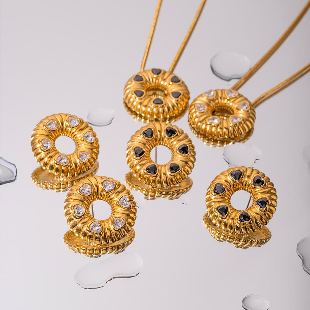 Beautiful gold ring holders with black and white gemstone accents, perfect for organizing and displaying rings. Elegant addition to any jewelry collection or store display.