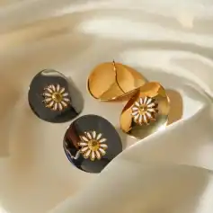 Daisy-shaped jewelry with black and gold accents, perfect for fashion-forward accessories. Shop stylish earrings at Monalisa Medical for premium quality and trendy designs.