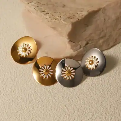 Boucles d'oreilles Daisy en or et argent avec design floral, parfaites pour un style tendance et sophistiqué.
