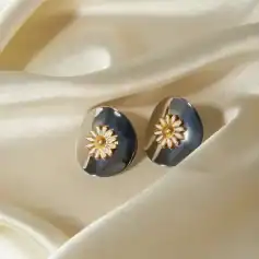 Daisy flower earrings with gold accents on shiny silver base, perfect for fashion-forward accessories. Enhance your style with these premium-quality, trendy jewelry pieces from Monalisa Store.