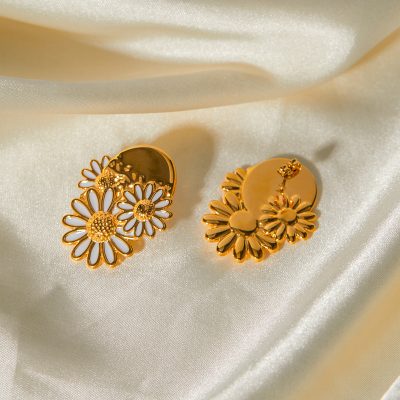 Elegant gold earrings featuring daisy-shaped cutouts and intricate floral details, perfect for enhancing your style and complementing modern or classic looks.