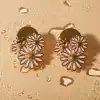 Elegant daisy flower earrings with gold and white enamel design, perfect for stylish accessories. High-quality jewelry ideal for fashion-conscious individuals.