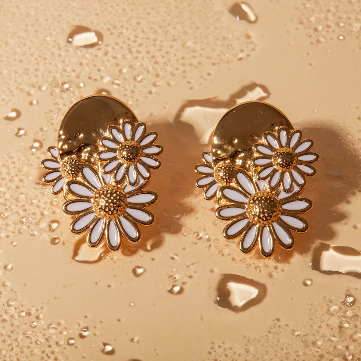 Elegant gold and white enamel daisy earrings, perfect for stylish women and jewelry lovers. Trendy floral jewelry piece for casual or special occasions.