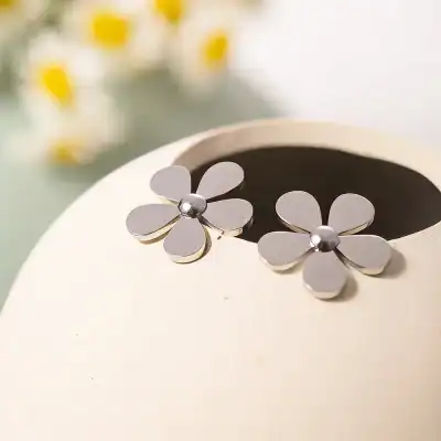 Sterling silver flower earrings with polished finish, perfect for women seeking stylish and trendy jewelry. Ideal for gifting or enhancing everyday fashion.