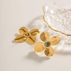Beautiful gold flower-shaped earrings featuring a polished and textured design, perfect for enhancing your style. Crafted with high-quality materials, these trendy accessories are ideal for any fashion-forward woman.