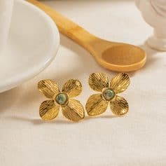 Stylish gold flower earrings featuring textured petals and a central pearl, perfect for enhancing any jewelry collection, available at Monalisa Store.