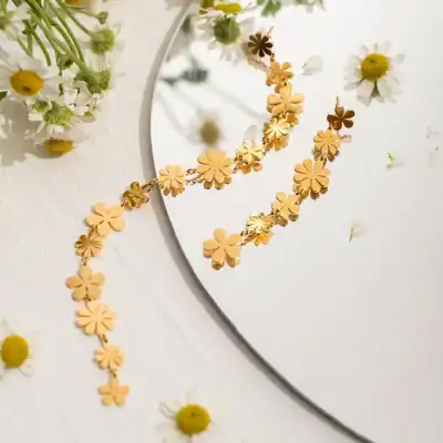 Stylish gold flower necklace and earring jewelry set perfect for women, featuring floral-inspired designs for an effortlessly chic look.