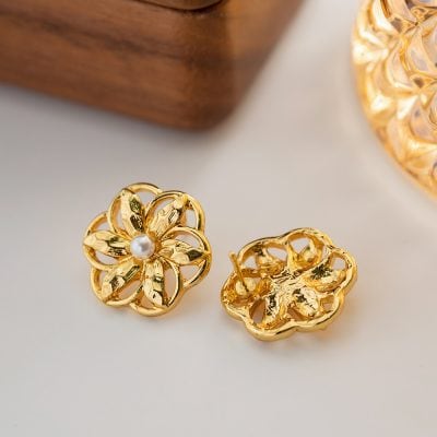 Gold flower-shaped earrings featuring intricate petal designs and a central pearl, perfect for sophisticated jewelry lovers. Handcrafted luxury jewelry from Mona Lisa Store.