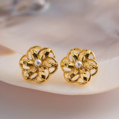 Gold floral earrings featuring intricate petal design and a central pearl, perfect for stylish accessories.