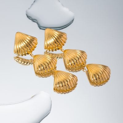 Stylish gold shell earrings perfect for fashion-forward jewelry lovers seeking elegant designer pieces.