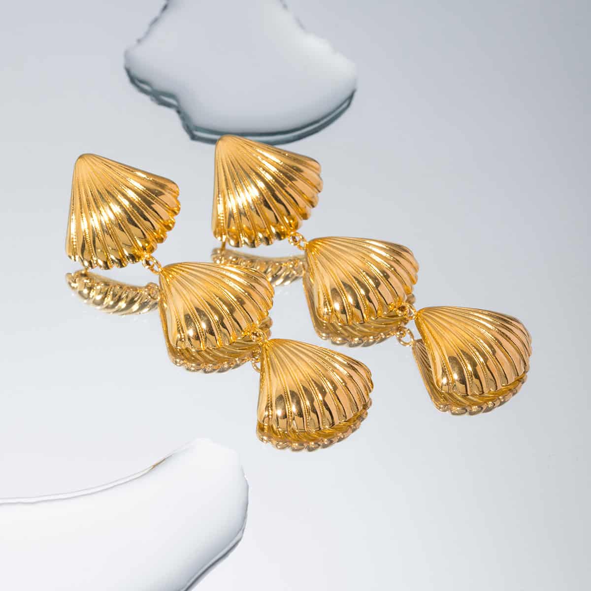Stylish gold shell earrings perfect for fashion-forward jewelry lovers seeking elegant designer pieces.