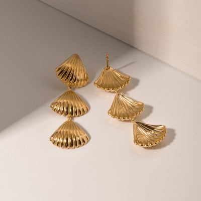 Stylish gold shell-shaped earrings perfect for fashion-forward women seeking unique statement jewelry. Ideal for parties, casual wear, or special occasions.