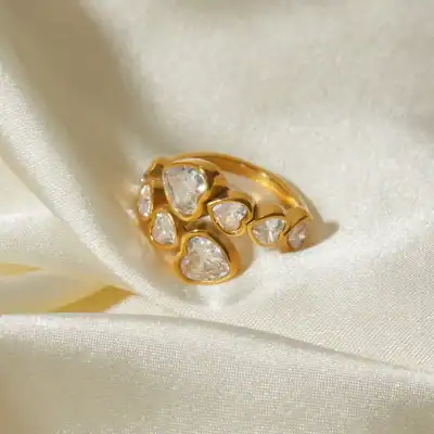Stunning gold-plated ring featuring multiple heart-shaped cubic zirconia stones, ideal for women's accessories and gift ideas.