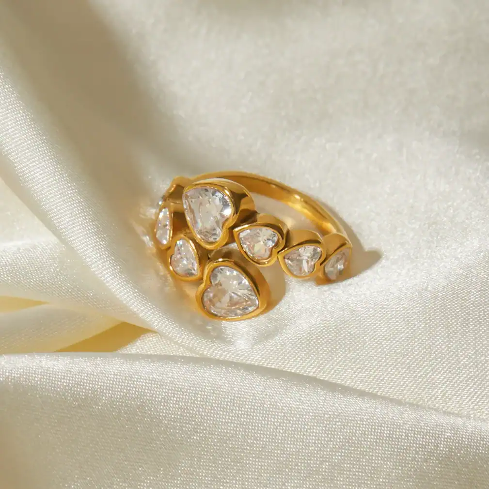 Stunning gold-plated ring featuring multiple heart-shaped cubic zirconia stones, ideal for women's accessories and gift ideas.