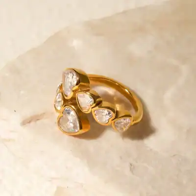 Luxurious gold ring featuring multiple heart-shaped diamond accents, perfect for special occasions or as a romantic gift. Crafted with high-quality materials for lasting beauty.