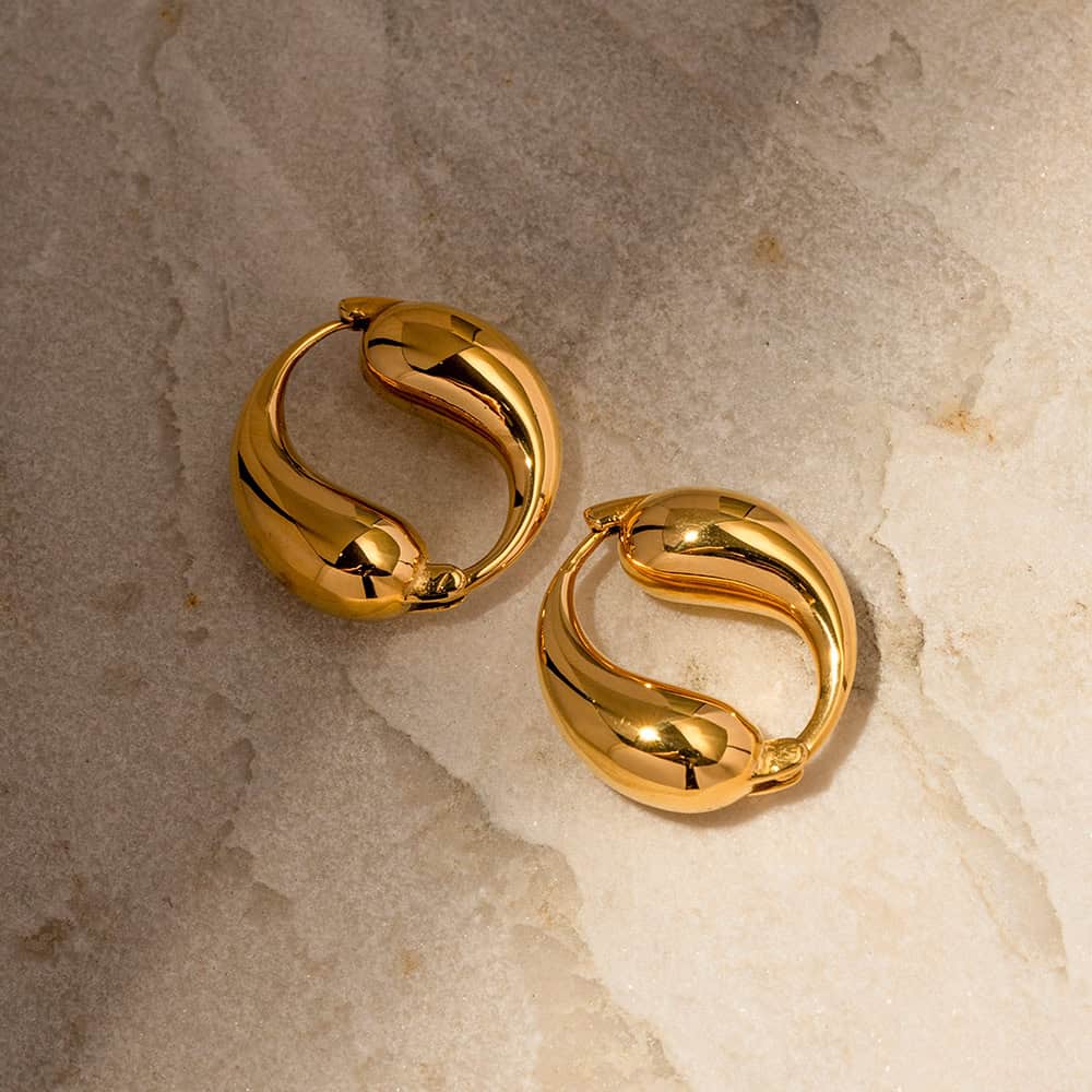 Luxurious gold hoop earrings with sleek, modern design. Perfect for enhancing your style with elegant jewelry from Monalisa Medical Store.