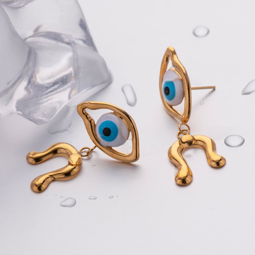Unique gold earrings with blue eye design and zodiac symbol, perfect for stylish jewelry lovers and eye jewelry enthusiasts.
